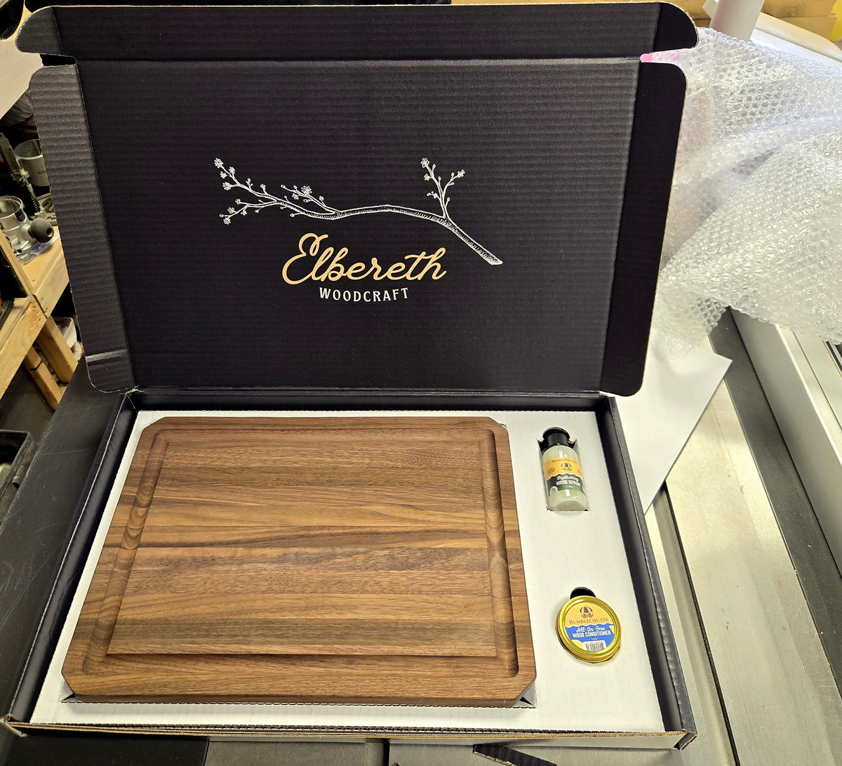 Walnut cutting board in an Elbereth Woodcraft gift box with wood serum and wood conditioner
